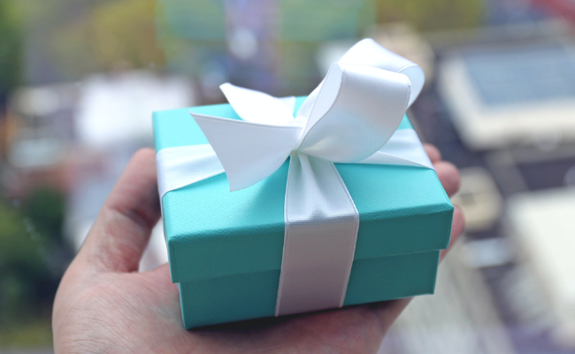 Hand holding Tiffany & Co. jewelry box