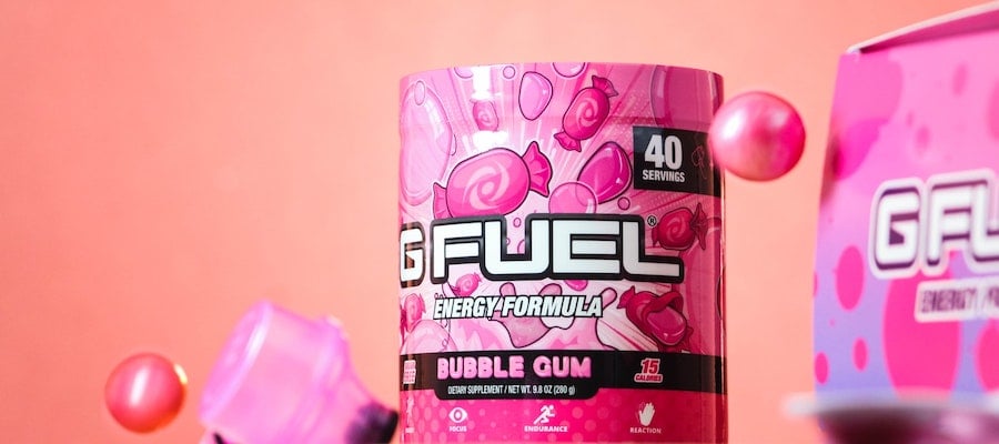 A container of bubble-gum-flavored GFuel energy formula in front of a pink background, by Jacob Rubich. 