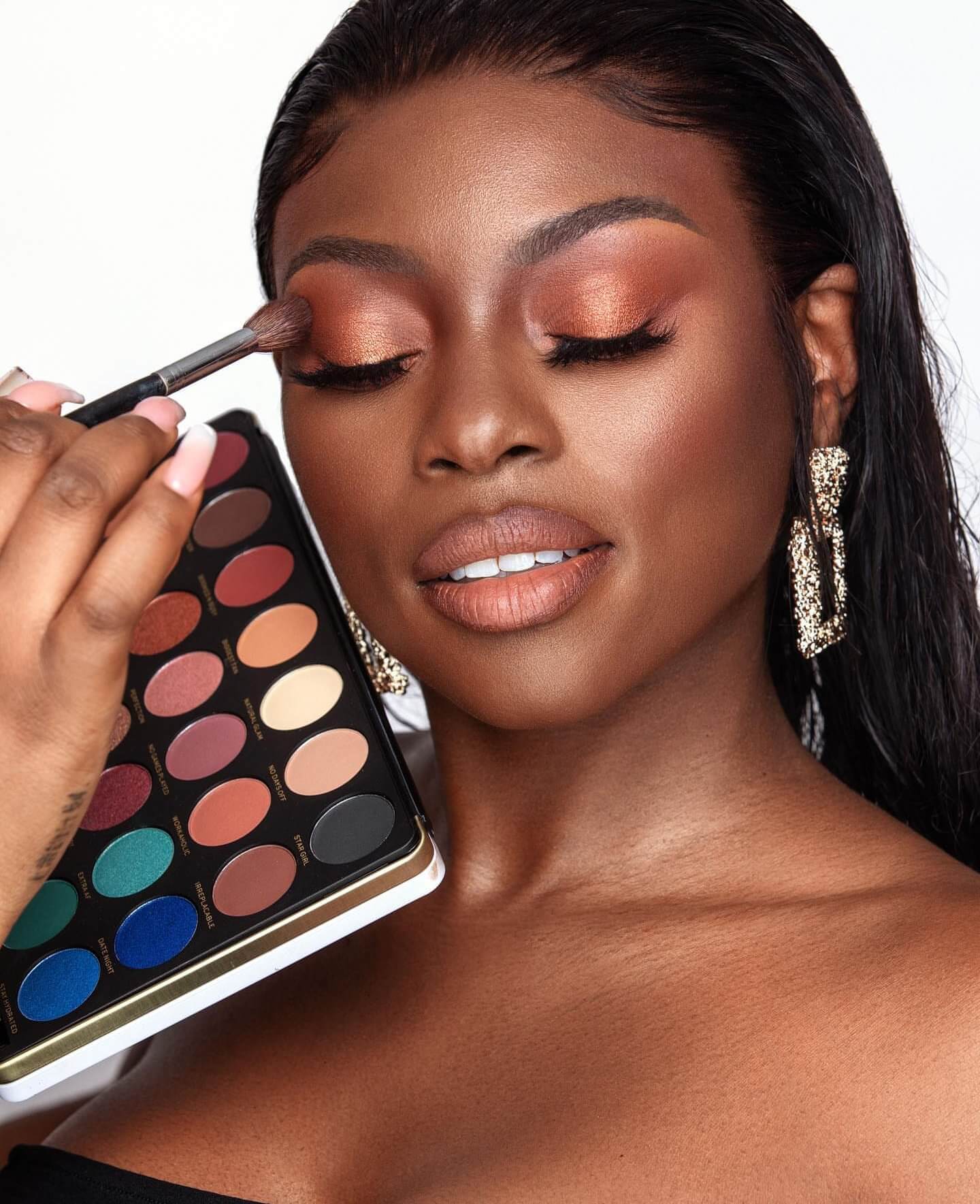 Beauty blogger Patricia Bright applies eyeshadow from her collaborative collection with Revolution Beauty.