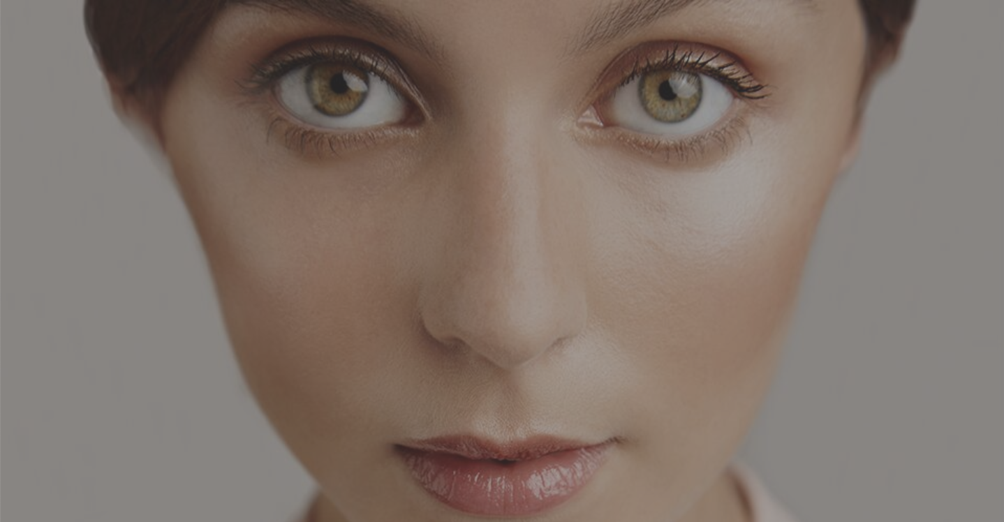 A close-up photo advertisement of a woman’s face from clean beauty brand W3LL People’s website.
