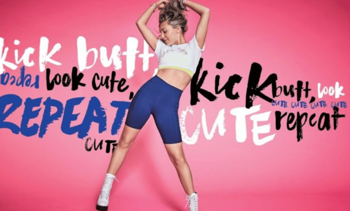 A model poses in an advertisement for Fabletics' #KickButtLookCute campaign.