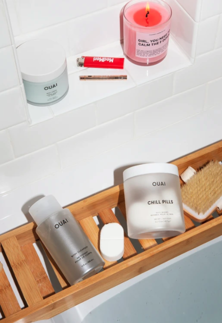 A flat-lay of several bath products, including Ouai’s Chill Pills and Body Cleanser.