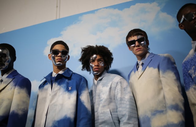 Models in sky-colored suits posing in Louis Vuitton’s Spring 2020 Fashion Show. 