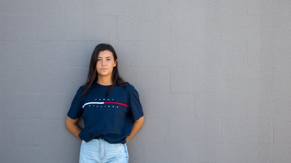 A woman poses in a Tommy Hilfiger top 