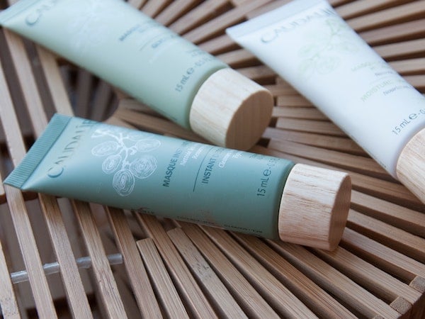 Several viral TikTok products from Caudalie skincare arranged on a wooden surface, by Chi via Unsplash.