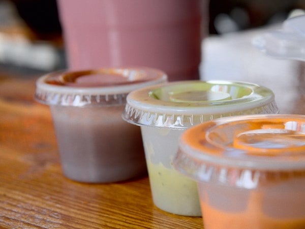 Three sauces from viral TikTok brand Chipotle in plastic containers, by Doris Morgan via Unsplash.