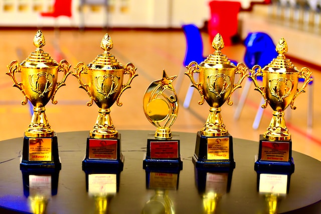 Five trophies on a table