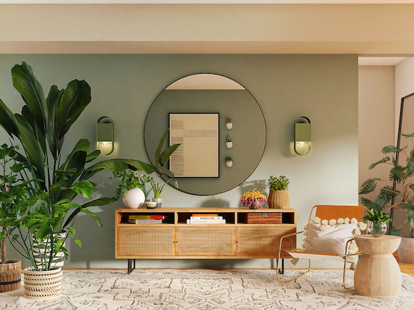 A boho-style living room with several large plants, a round wall mirror, and bamboo cabinets, by Spacejoy via Unsplash.