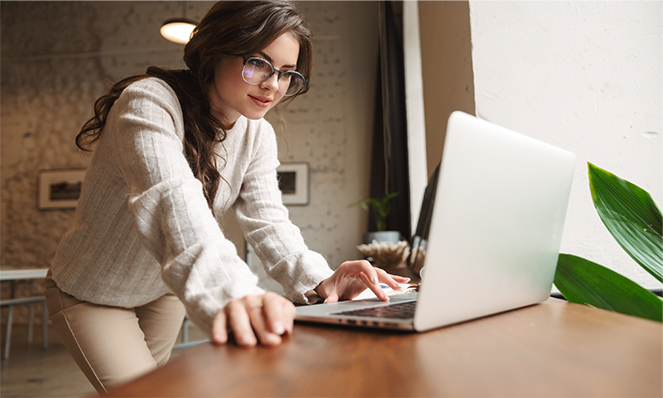 A woman works on her laptop