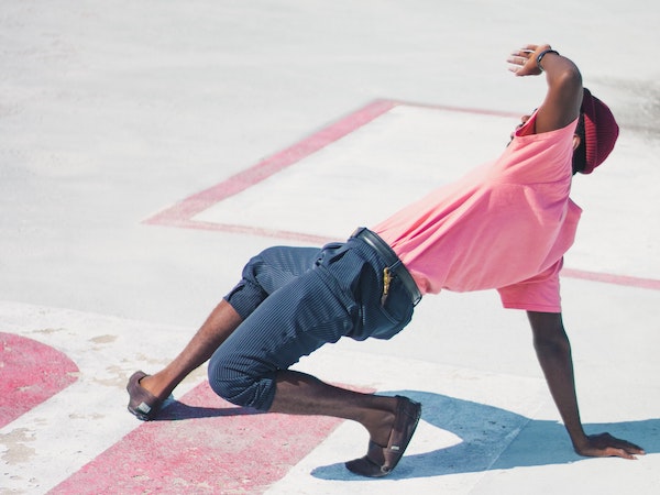 A TikTok creator breakdancing on pavement, by Joseph Frank via Unsplash.