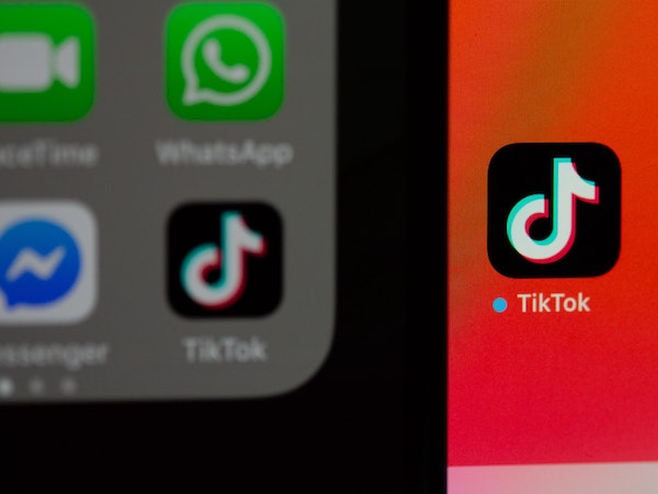A close-up of app icons including TikTok on a smartphone, by Solen Feyissa via Unsplash.