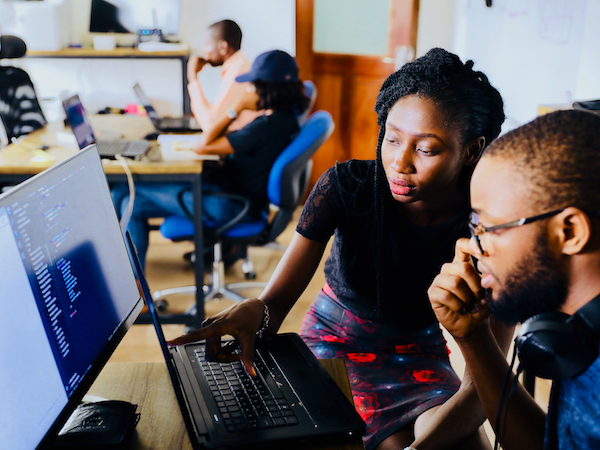 a woman and a man viewing the best influencer marketing platform on a computer monitor